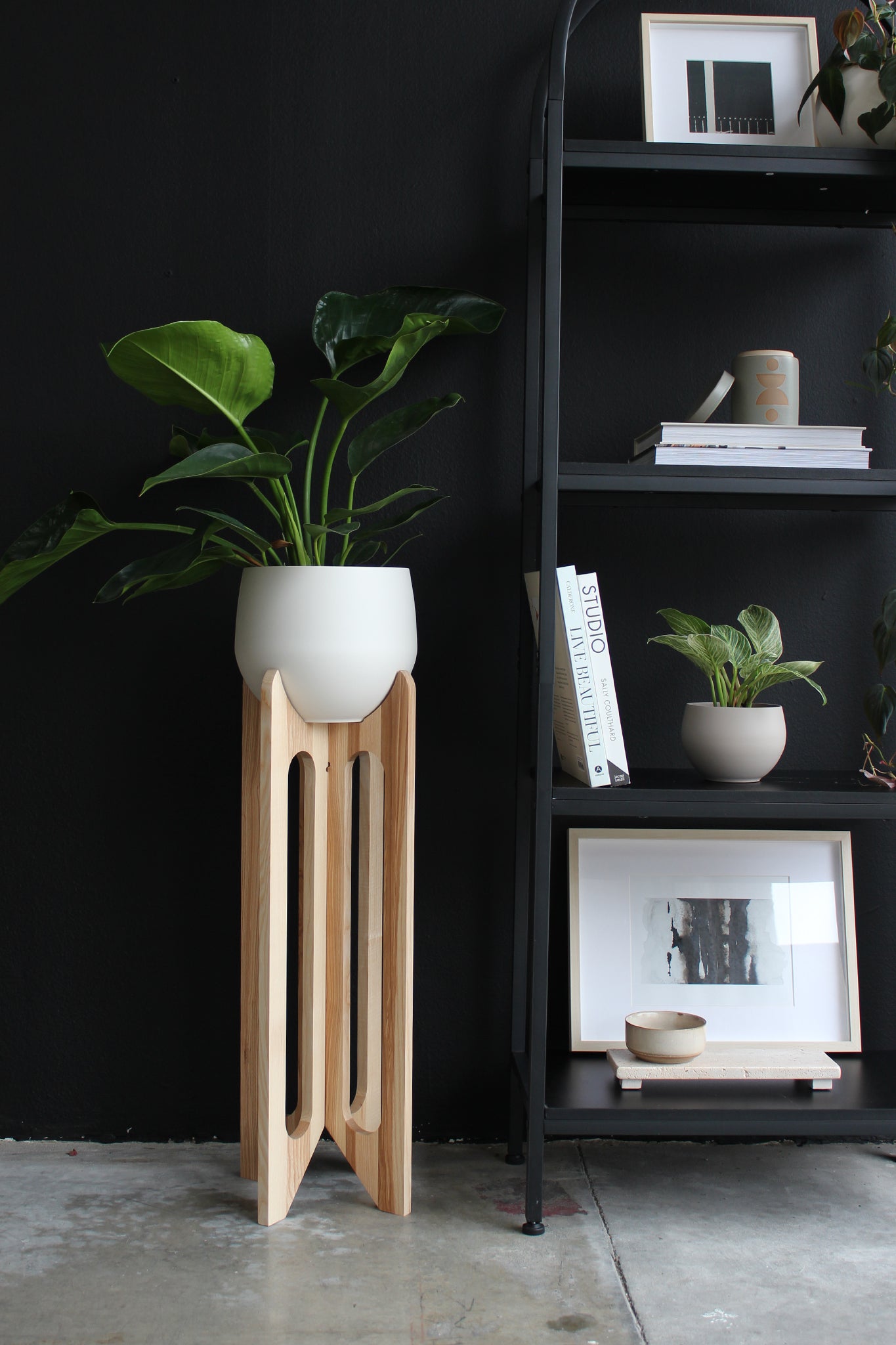 tall modern plant stand in moody industrial modern space