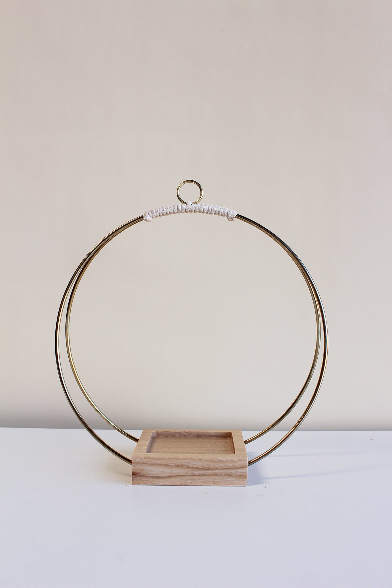 medium gold circular hanging planter with light wood and no pot